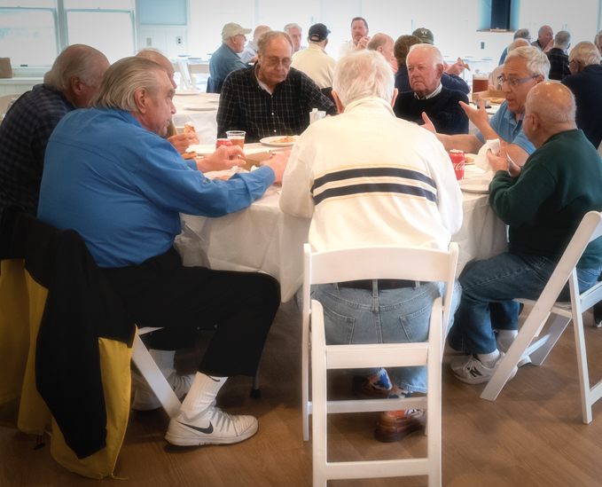 Members enjoy socializing and eating pizza at the Chatham Men's Club's final meeting of the season.